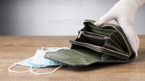 Woman holding empty wallet face mask