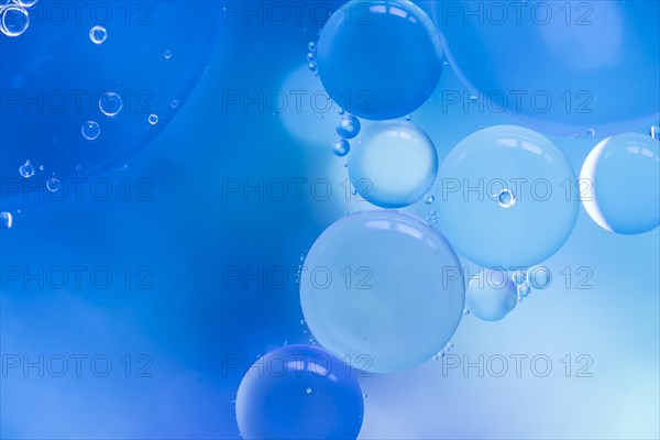 Abstract bubbles blue colored blurred background