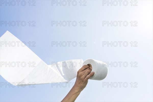 Hand with toilet paper roll
