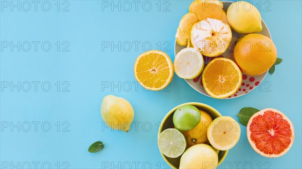 Overhead view juicy citrus fruits blue backdrop