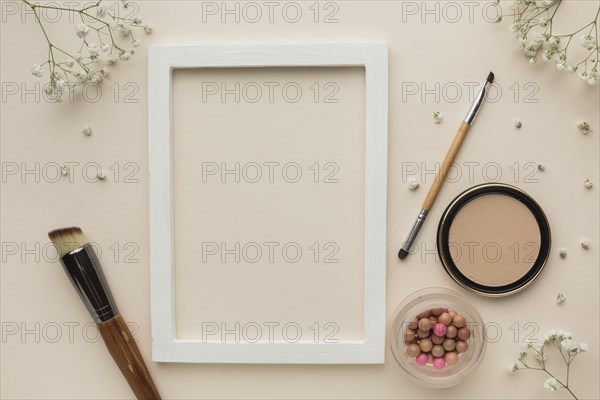 Frame with makeup products beside