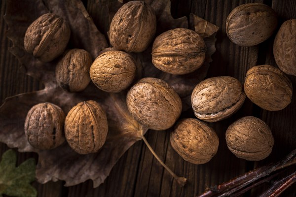 Close up walnuts wooden table with leaves