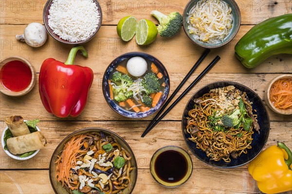 Overhead view traditional thai food with sauces wooden plank