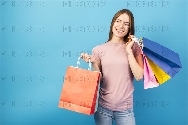 Mid shot woman holding bags looking away