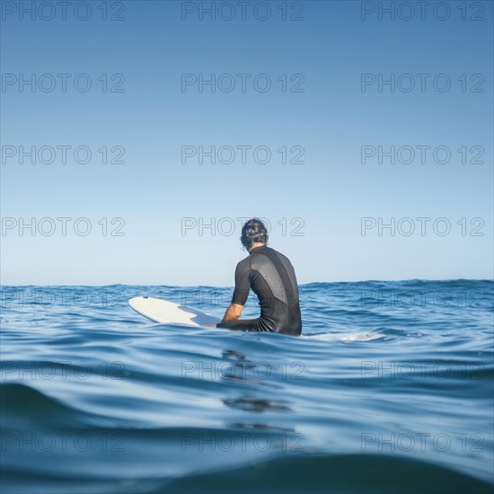 Man sitting water from