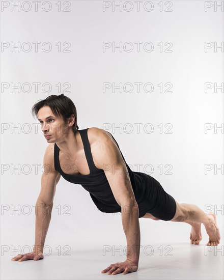 Side view athletic man doing push ups