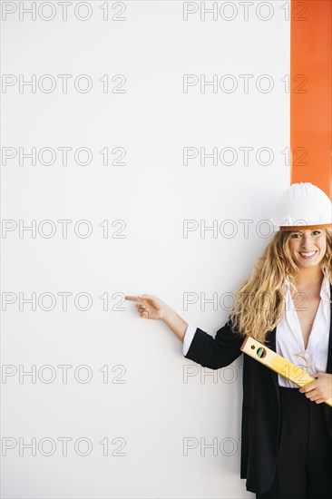 Presentation concept with businesswoman holding level