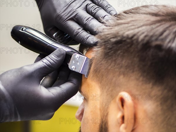 Close up hairdresser hands with gloves