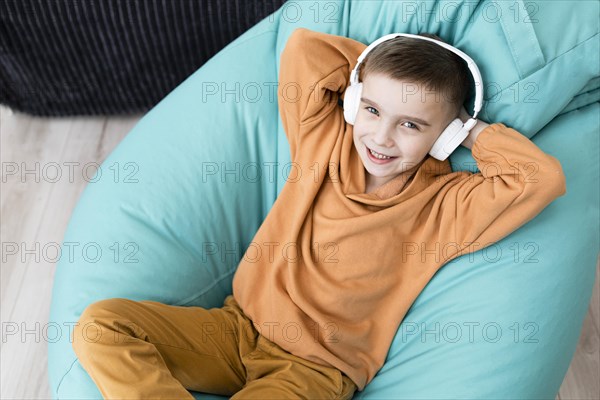 Smiley kid sitting bean bag chair