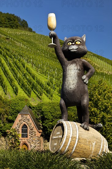 Sculpture Black Cat in front of wine-growing area