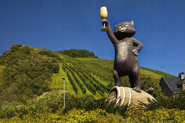 Sculpture Black Cat in front of wine-growing area