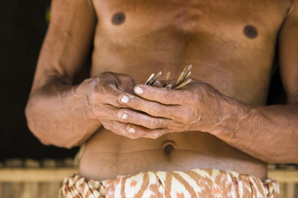 Man holding rusted nails