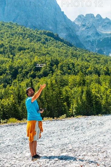 Drone pilot man taking off exploring new places in the mountain. Use of drone photography