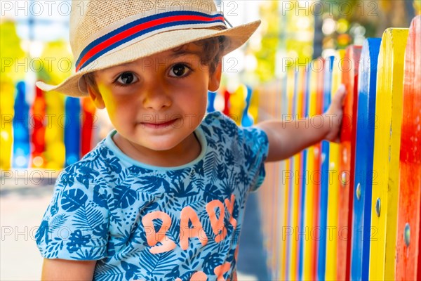 Portrait of a happy boy with hat playing in a playground
