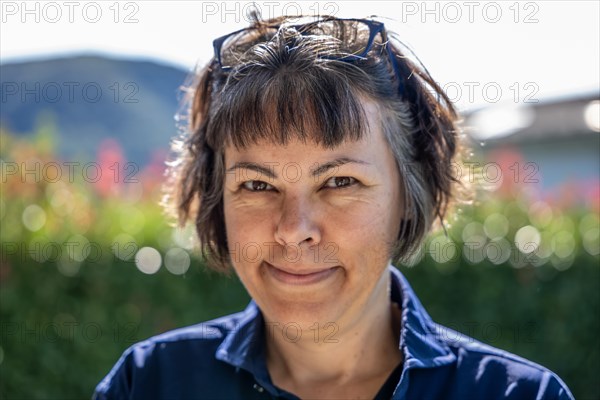 Headshot on a Happy Smiling Woman with Eyeglasses in a Sunny Day in Switzerland