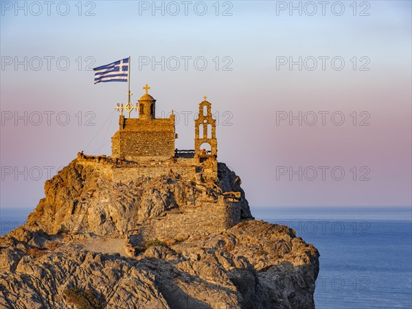 Chapel of St. Paisios perched on rocks at sunrise