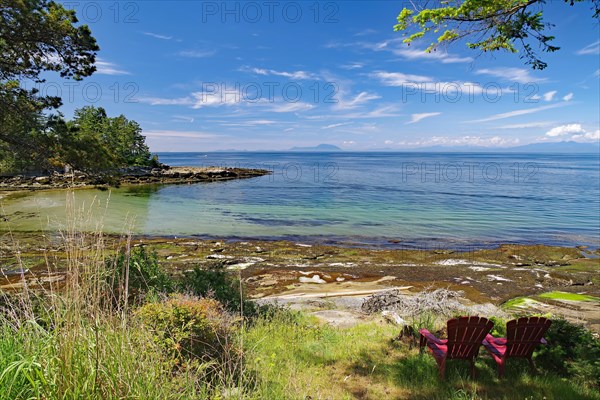 Beach and idyllic bay with two chairs