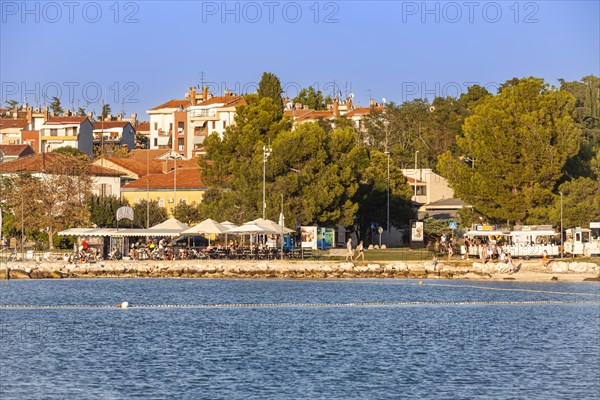 Beach on the stone coast of City Beach of Porec