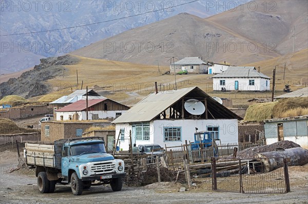 Old truck and houses in the small rural village Sary-Tash in the Alay Valley of Osh Region