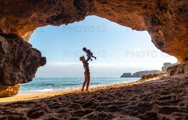 Having fun with the son in the beach cave in the Algarve