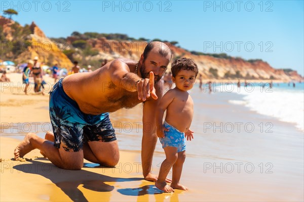 Father playing in the sand