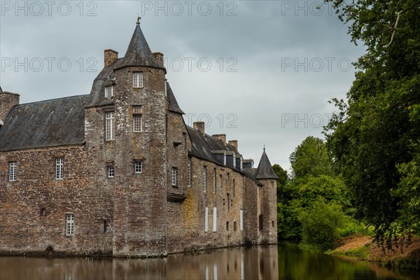 The medieval Chateau Trecesson by the lake