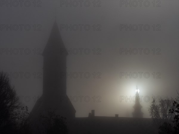 Church tower in the morning mist