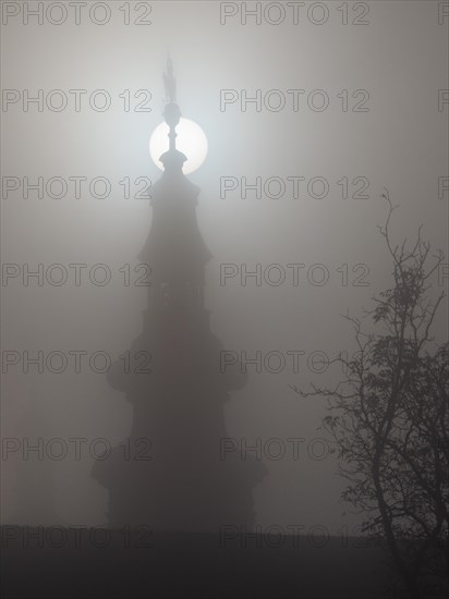 Church tower in the morning mist