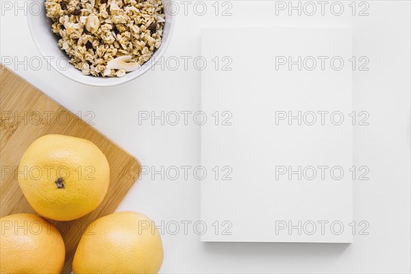 Book cover mockup with oranges cereals