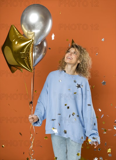 Happy woman holding balloons