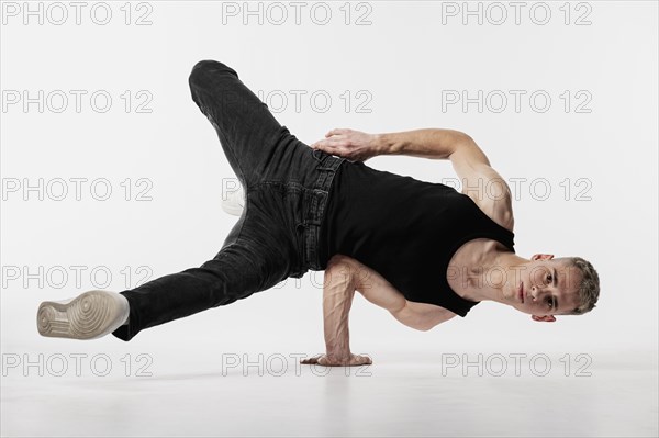 Male dancer tank top jeans making dance move