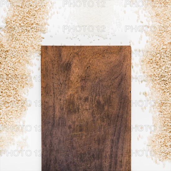 Uncooked rice with wooden chopping board