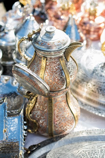 Ancient metal jug in oriental style in antique market