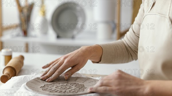 Close up hands decorating plate