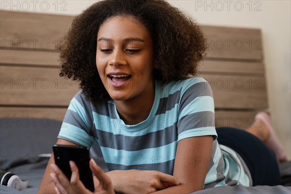 Medium shot girl holding smartphone