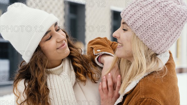 Young girlfriends outdoor looking each other