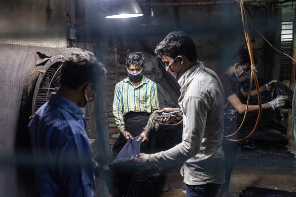 Workers colouring jeans in a textile factory