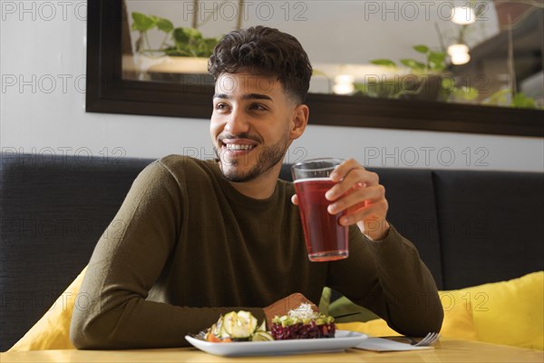 Medium shot happy man holding cup