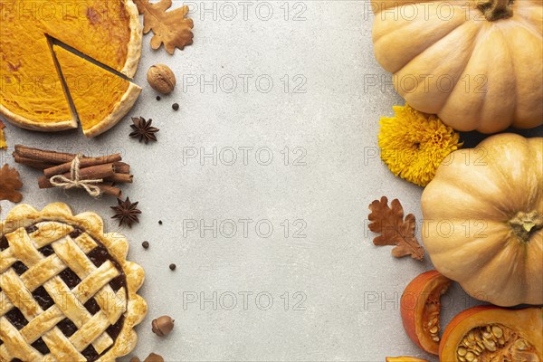 Flat lay decoration with pumpkins stucco background