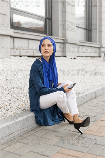Gorgeous girl with hijab sitting outside