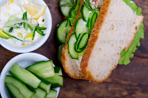 Fresh vegetarian sandwich with garlic cheese dip salad on rustic table