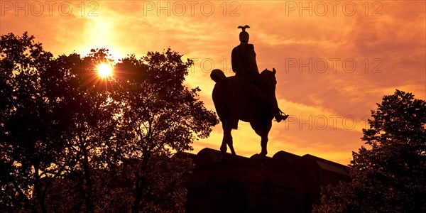 Equestrian statue of Kaiser Wilhelm II backlit at sunset