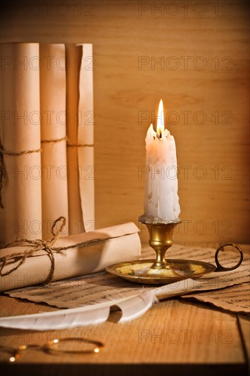 Antic candle with rool of paper