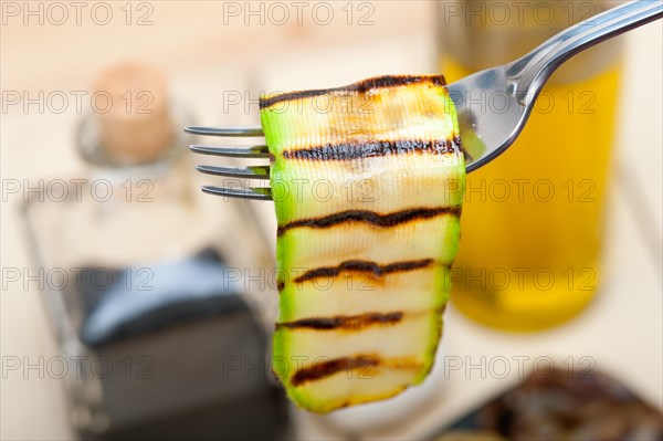 Grilled zucchini courgette on a fork macro close up