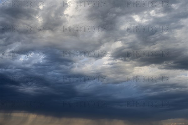 Dramatic cloud formation and veil of rain during a summer thunderstorm