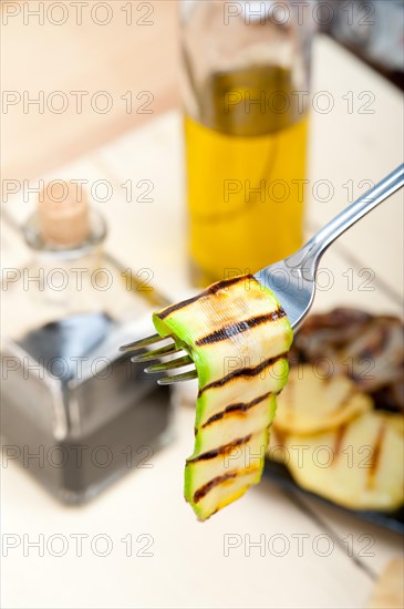 Grilled zucchini courgette on a fork macro close up