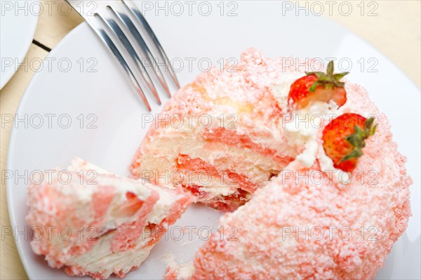 Fresh pink strawberry and whipped cream dessert macro close up