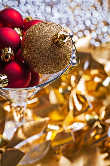 Christmas baubles gold and red in a wine glass