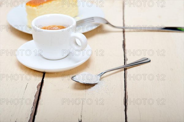 Italian espresso coffee and cheese cake over white wood table