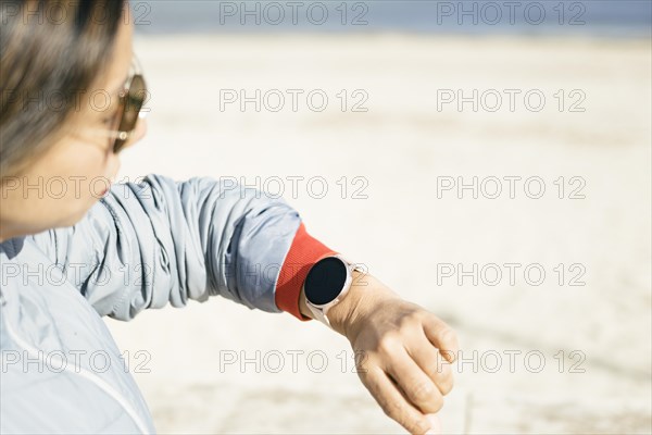 View of latina woman looking at smart watch